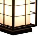 Illuminated geometric lantern with horizontal slats casting warm light in modern setting