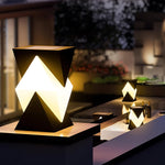 Multiple geometric lighting elements providing dramatic evening illumination for contemporary outdoor space