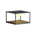 Contemporary outdoor light with geometric design creating warm ambient glow on concrete surface