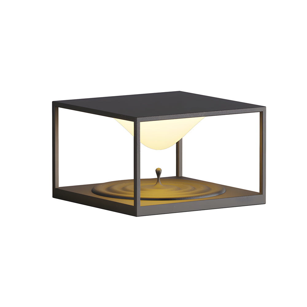 Contemporary outdoor light with geometric design creating warm ambient glow on concrete surface