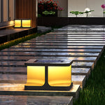 Geometric post lights creating warm ambient lighting along wooden deck with evening garden atmosphere