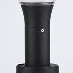 Bollard light providing warm ambient lighting along curved residential walkway