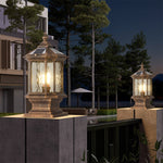 Pair of heritage-style post lights illuminating landscaped entrance with evening twilight atmosphere