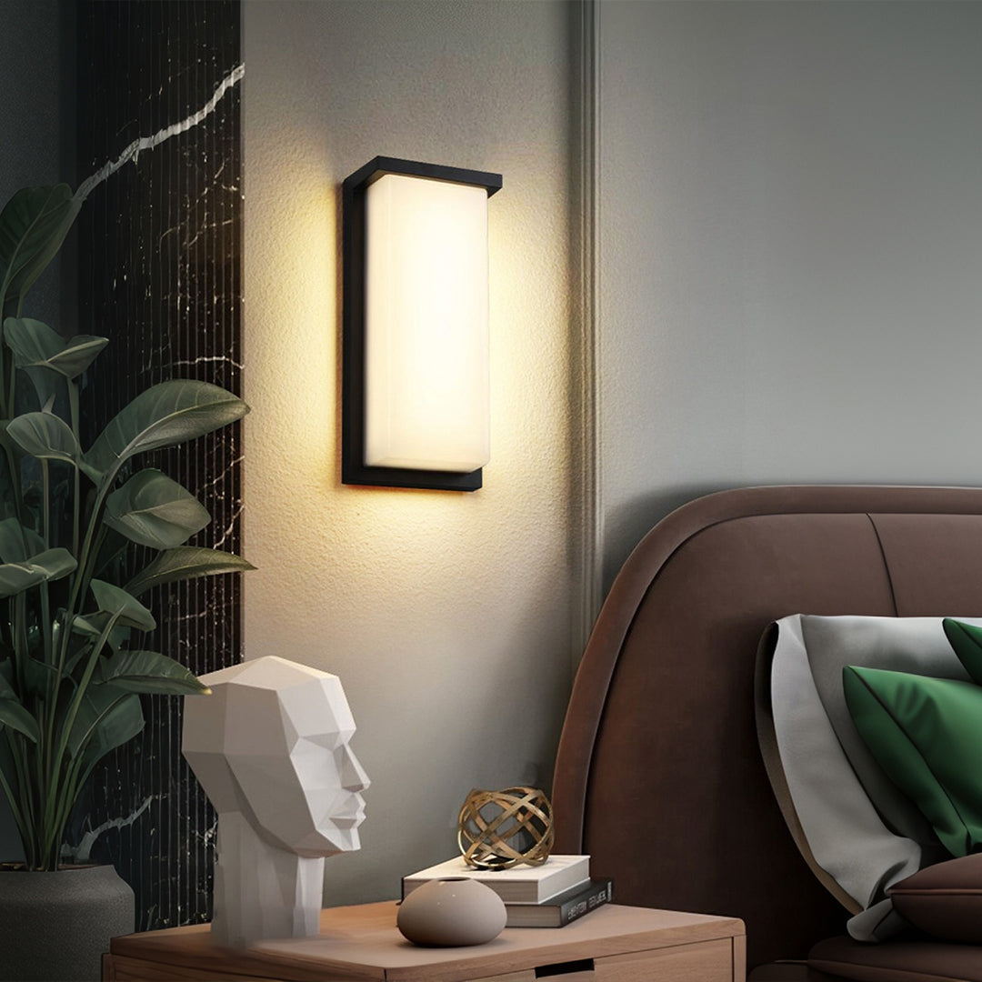 Indoor wall sconce with warm LED lighting creating cozy atmosphere in modern bedroom setting
