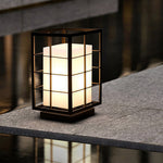 Japanese lantern light fixture positioned on concrete ledge demonstrating outdoor placement
