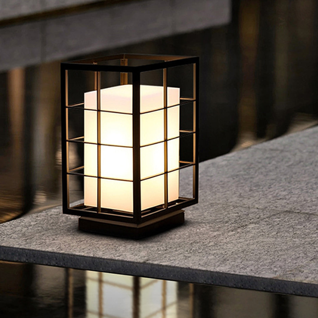 Japanese lantern light fixture positioned on concrete ledge demonstrating outdoor placement