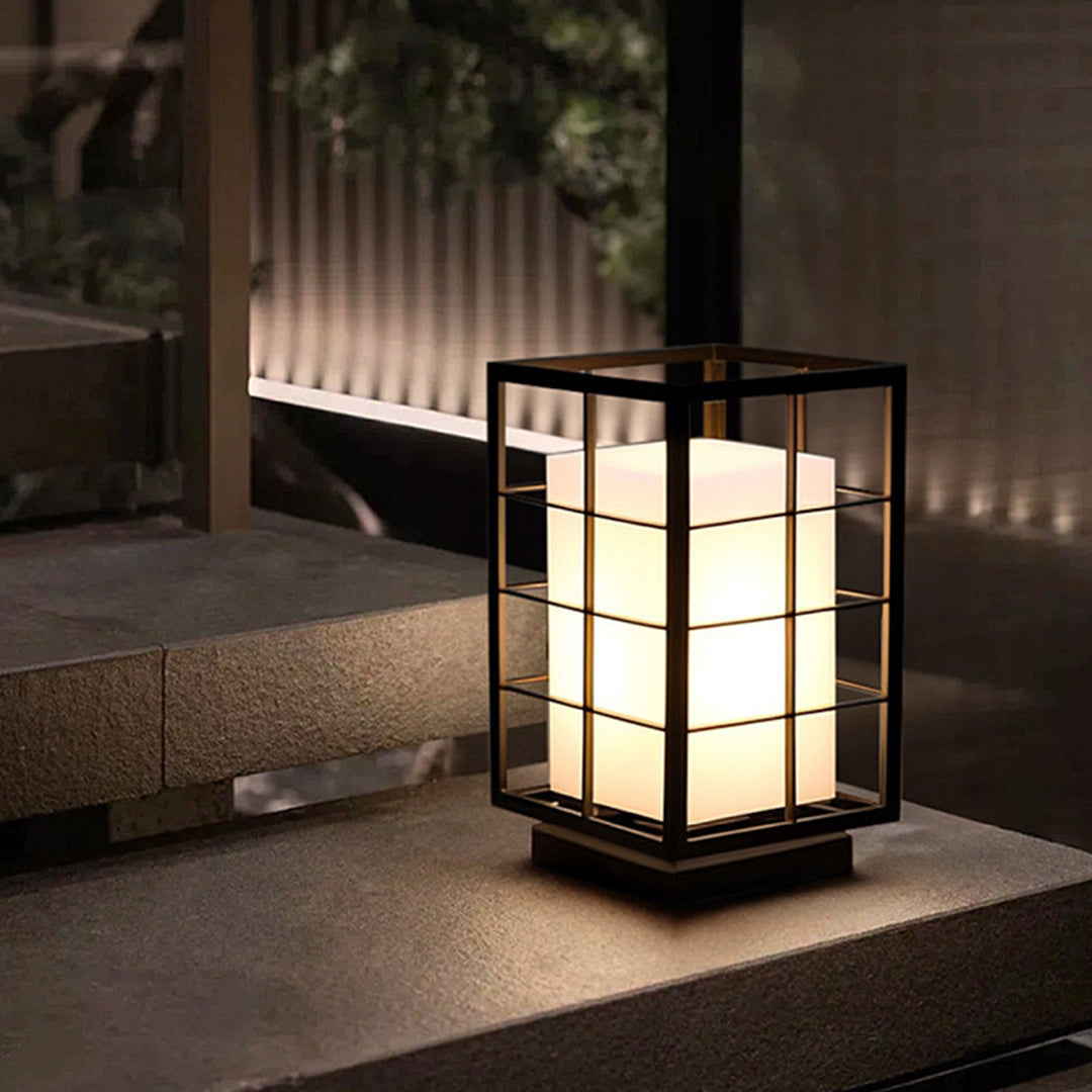 Single lantern light fixture on modern outdoor deck with architectural background