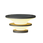 Layered post cap light with bronze and black finish displayed on neutral studio background