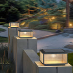 Multiple LED cube lights arranged on modern concrete steps creating sophisticated evening landscape design