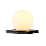 Warm LED sphere light with frosted glass globe on black square base against white background