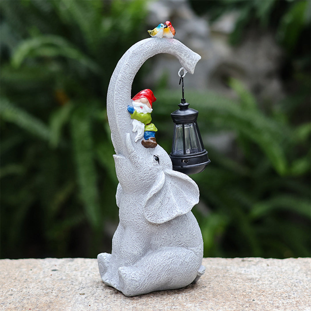 Light gray elephant garden ornament with hanging lantern and small colorful bird decoration