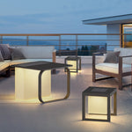 Luxury outdoor seating area enhanced with modern cube lighting fixtures during beautiful sunset