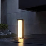 Minimalist outdoor space with sleek column light creating dramatic architectural lighting against modern wall