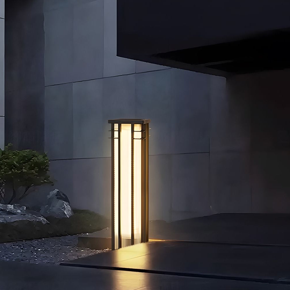 Minimalist outdoor space with sleek column light creating dramatic architectural lighting against modern wall