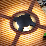 Close-up view of black cylindrical ground fixture showing precision-engineered directional design