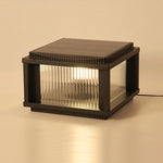Indoor studio shot of modern solar light fixture with ribbed glass diffuser on neutral background