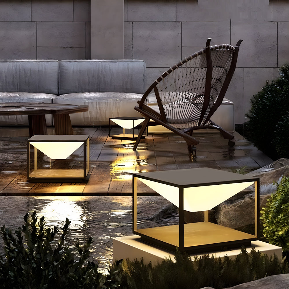 Outdoor lounge area featuring geometric light fixtures alongside modern furniture and decorative elements