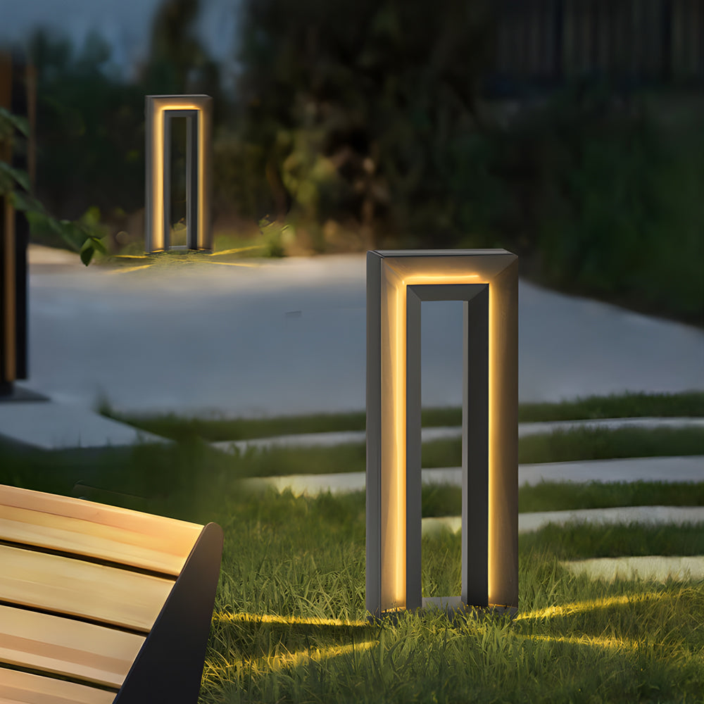 Elegant pathway lighting installation featuring tall bollards illuminating modern landscape design
