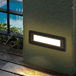 Multiple LED step lights installed along modern building exterior providing safe navigation lighting