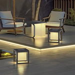 Sophisticated outdoor lounge space featuring multiple illuminated cube lights creating dramatic evening ambiance
