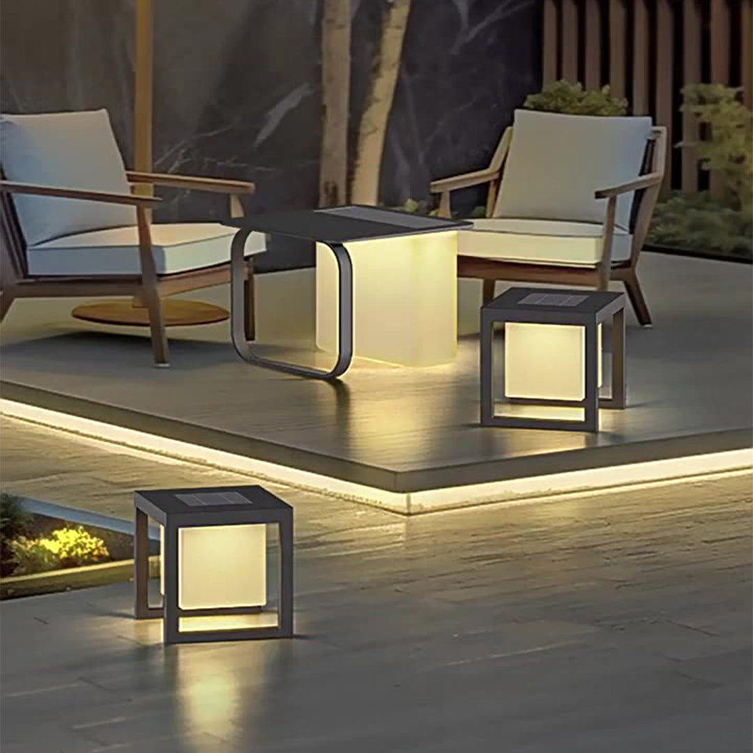 Sophisticated outdoor lounge space featuring multiple illuminated cube lights creating dramatic evening ambiance