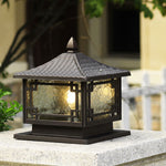 Pagoda-style outdoor lantern photographed in natural garden setting with stone base