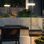 Floor lamp illuminating outdoor patio seating area