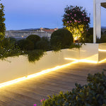 Modern patio with solar strip lighting installed under deck railings creating ambient glow