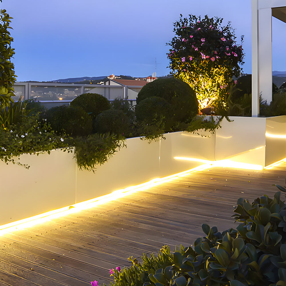 Modern patio with solar strip lighting installed under deck railings creating ambient glow