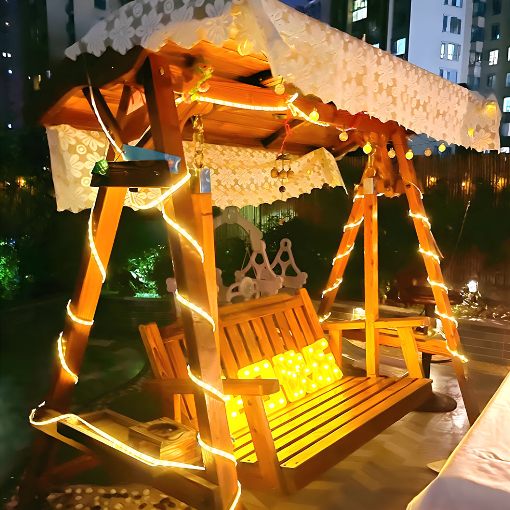 Garden pergola decorated with solar LED strip lights for cozy outdoor dining atmosphere