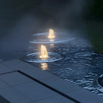 Modern pool deck with integrated underwater LED lights creating evening ambiance