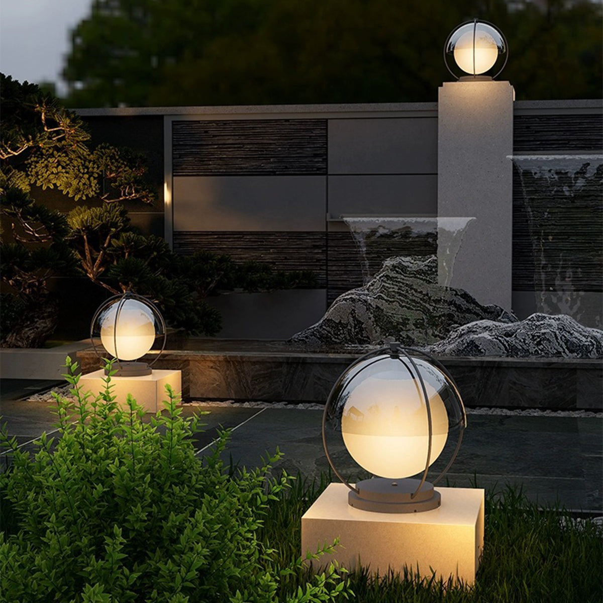Professional landscape lighting installation featuring illuminated orb lights on concrete platforms