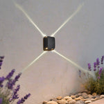 Elegant residential entrance gate with symmetrical wall-mounted lighting and classic architectural columns