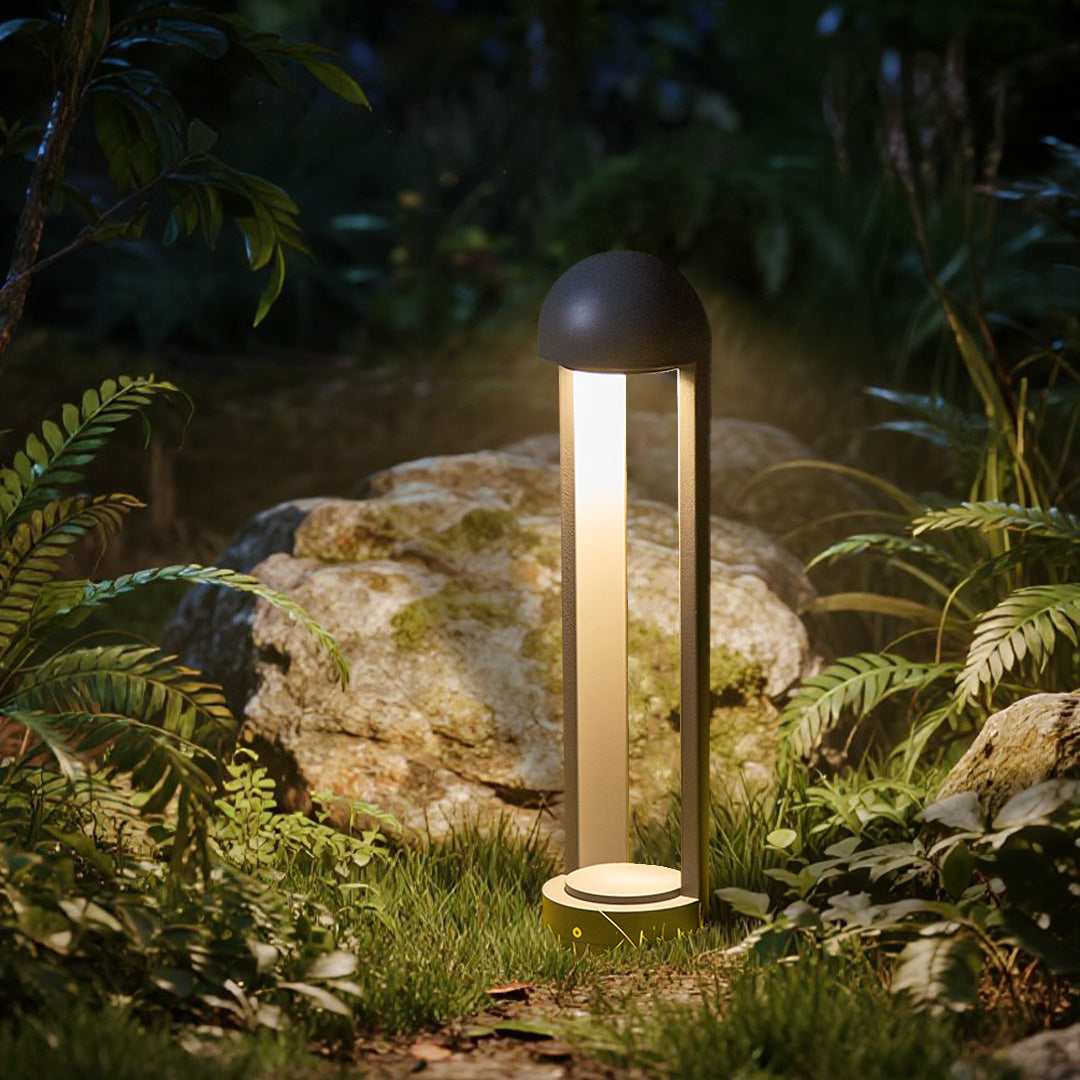 Contemporary bollard lights creating warm accent lighting among natural rock garden features
