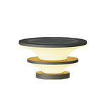 Sculptural outdoor light with stacked disc design featuring contrasting dark and light materials