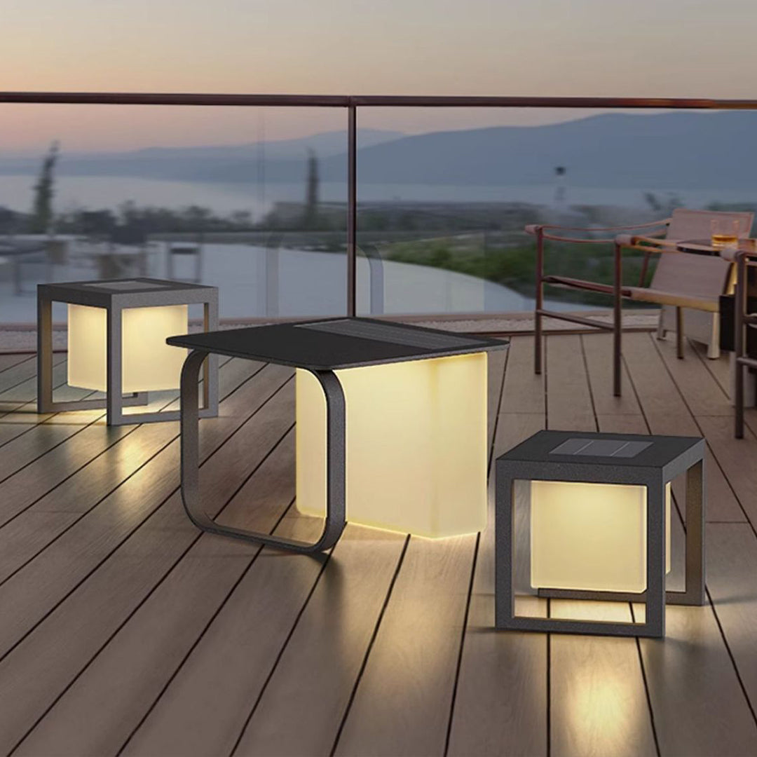 Elegant solar cube lights creating warm pathway lighting on contemporary wooden deck at dusk