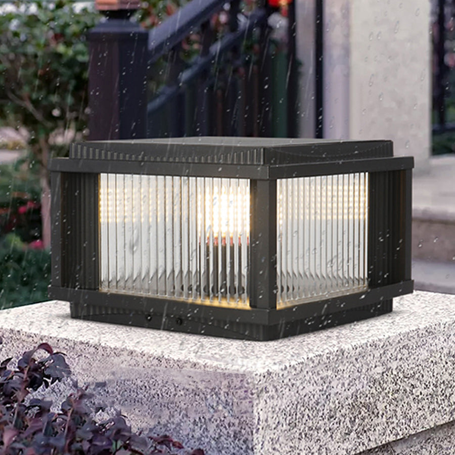Modern solar deck light with ribbed glass panels installed on white concrete surface