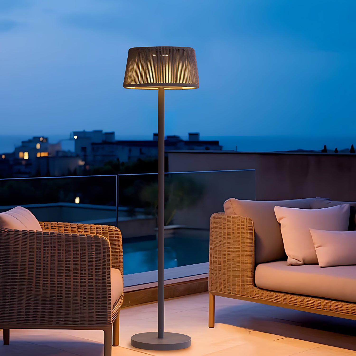 Contemporary solar floor lamp illuminating luxury outdoor seating area during evening twilight hours