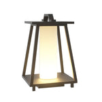 Modern solar lantern with black metal frame and warm LED light in geometric tapered design