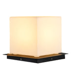 Square LED cube light with soft white illumination on modern black platform base