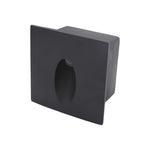Square black recessed lighting fixture with central aperture for wall mounting