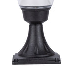 Decorative acorn light fixture mounted on stone surface with landscape lighting