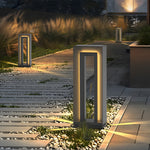 Stone pathway lined with contemporary bollard lights creating warm evening ambiance