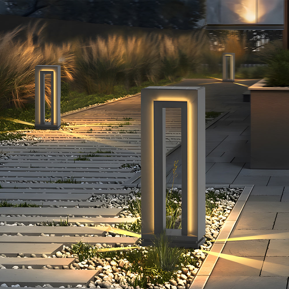 Stone pathway lined with contemporary bollard lights creating warm evening ambiance