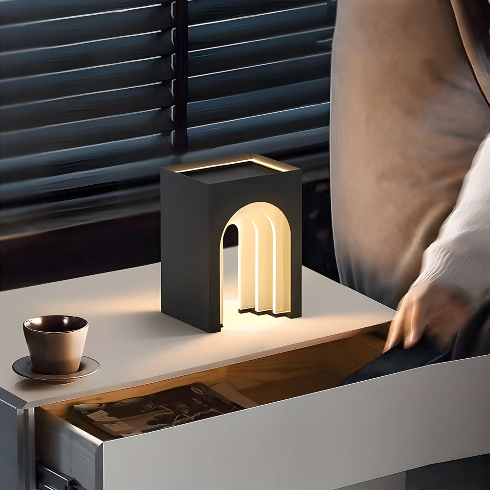 Close-up of arch lamp on wooden surface with hand reaching
