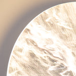 Close-up detail of textured wall light showing natural stone pattern and organic surface finish