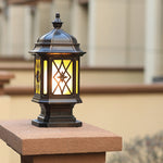 Traditional lantern-style post cap light with diamond lattice glass pattern mounted on wooden fence post