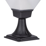 Traditional-style bollard light casting warm glow in naturalistic garden setting