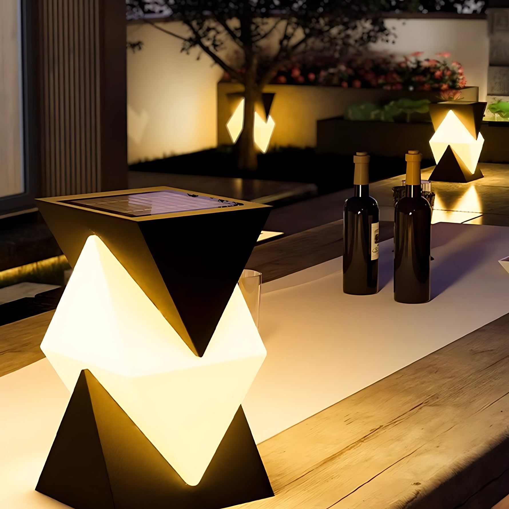 Series of triangular post lights creating striking architectural accent lighting along modern pathway