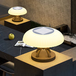 Modern UFO-shaped outdoor light fixture with warm LED glow installed on contemporary concrete plaza surface
